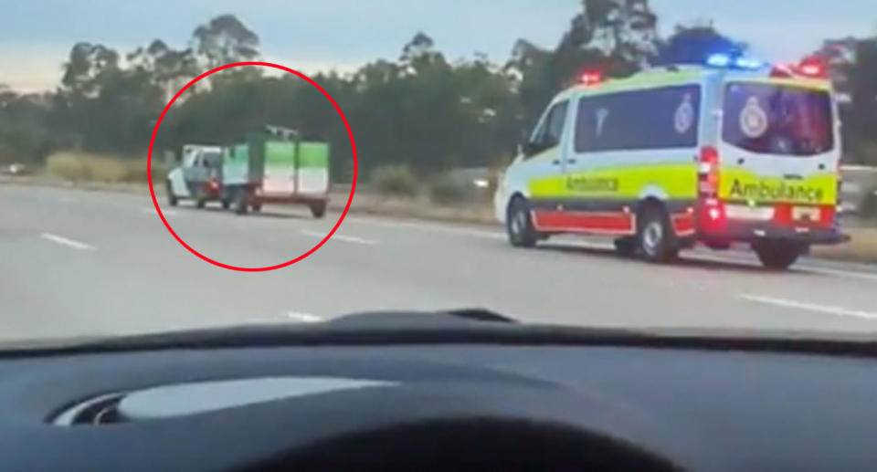 Ute driving on Queensland highway blocking ambulance. 