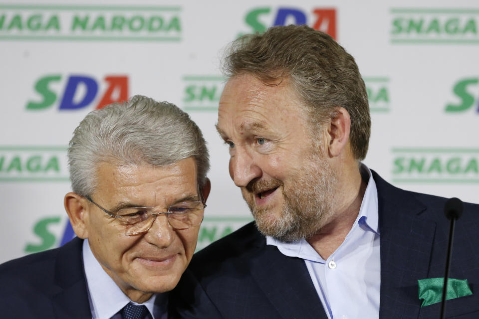 Candidate of Party for Democratic Action Sefik Dzaferovic, left, talks with Bakir Izetbegovic, former Bosnian member of Bosnian tri partite Presidency, right, as they celebrate unofficial results of election in Sarajevo, Bosnia, Monday, Oct. 8, 2018. (AP Photo/Amel Emric)