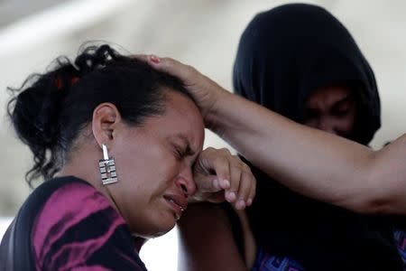 A woman is seen crying after receiving the information that her husband was one of the inmates who died during a prison riot, in front of the Medical Legal Institute in Manaus, Brazil, January 3, 2017. REUTERS/Ueslei Marcelino