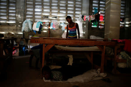 People start waking up in the morning after sleeping at a partially destroyed church used as a shelter after Hurricane Matthew hit Jeremie, Haiti, October 18, 2016. REUTERS/Carlos Garcia Rawlins