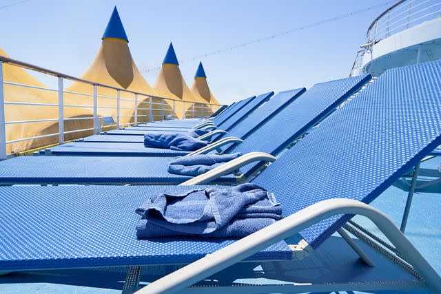 <p>Getty Images</p> Stock image of towels on deck chairs.