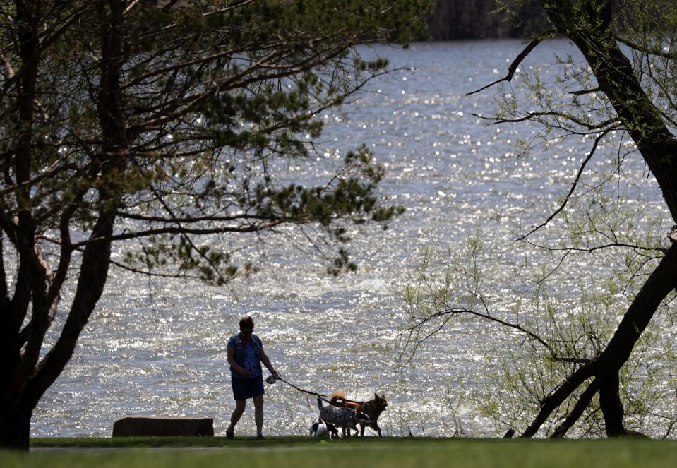 Louiose Becklund, Kaukauna, walks her dogs on a trail along the Fox River at Island Park on Monday, May 7, 2018 in Little Chute, Wis.
Wm. Glasheen/USA TODAY NETWORK-Wisconsin