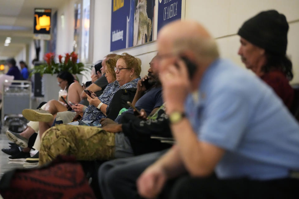 Travelers wait for their flight at Midway International Airport in Chicago, Wednesday, July 12, 2023. A tornado touched down Wednesday evening near Chicago’s O’Hare International Airport, prompting passengers to take shelter and disrupting hundreds of flights. There were no immediate reports of injuries. (AP Photo/Nam Y. Huh)