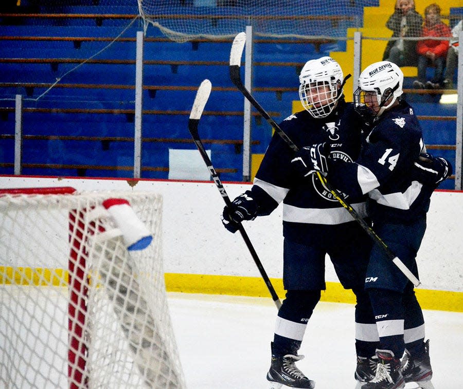 Sault High's Garrett Gorsuch (14) and a teammate celebrate after Gorsuch scored to tie the game at 2-2 in the second period.