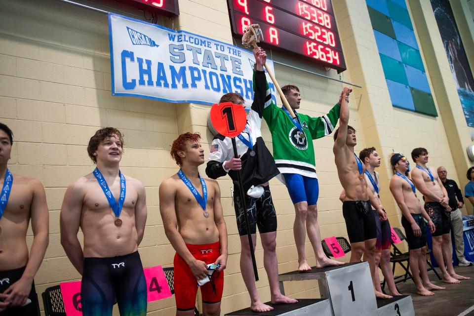 Fossil Ridge's Brennen O'Neil takes to the podium for his first place finish in the 200 yard IM during the Class 5A state swimming championships on Saturday, May 11, 2024 at the Veterans Memorial Aquatics Center in Thornton, Colo.