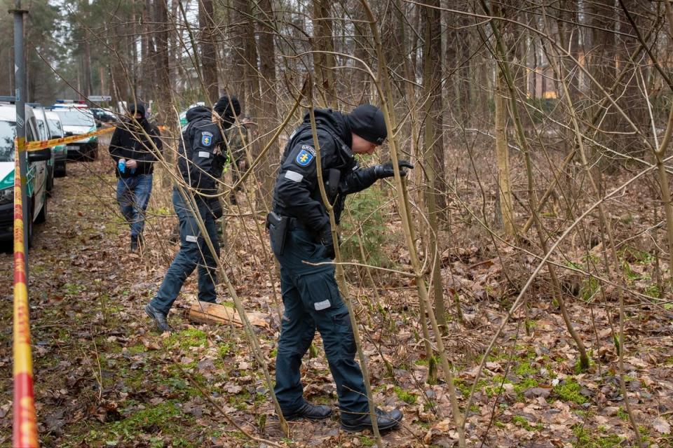 Police officers inspects the area near Leonid Volkov’s house on March 13, following the attack (AP)