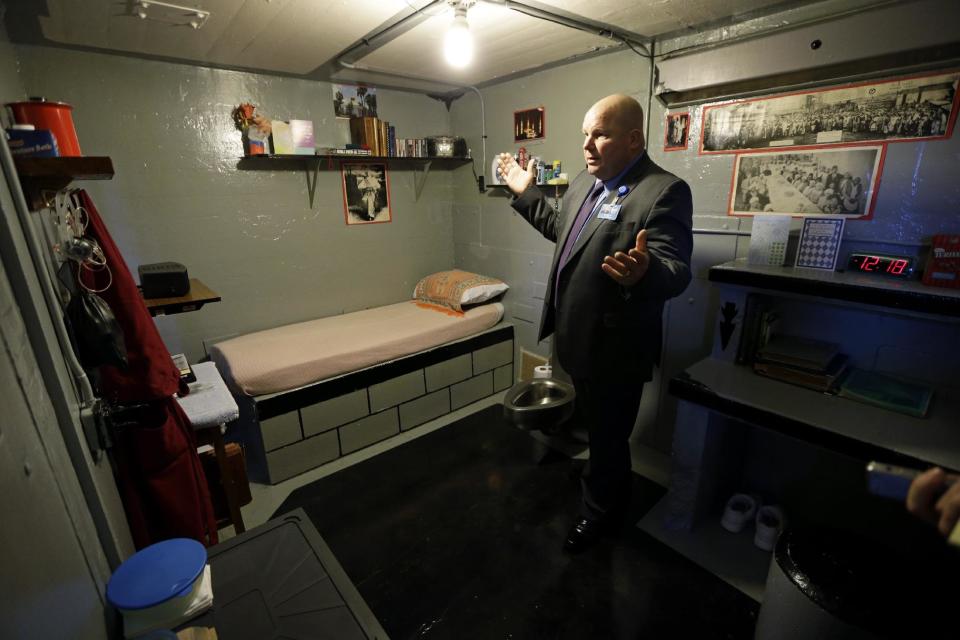 In this Monday, Nov. 18, 2013 photo, Warden Nick Ludwick stands in an inmate's cell at the Iowa State Penitentiary, in Fort Madison, Iowa. The penitentiary, the oldest in use west of the Mississippi River with a history dating back to 1839, is set to close when a $130 million replacement opens down the road next year. (AP Photo/Charlie Neibergall)