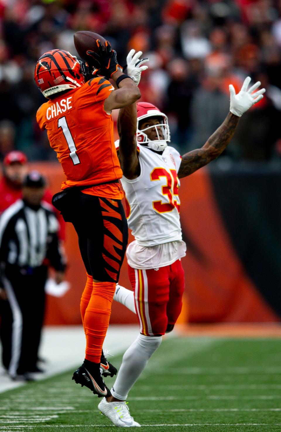 Cincinnati Bengals wide receiver Ja'Marr Chase (1) makes a catch over Kansas City Chiefs cornerback Charvarius Ward (35) in the second half of the NFL game on Sunday, Jan. 2, 2022, at Paul Brown Stadium in Cincinnati. Cincinnati Bengals defeated Kansas City Chiefs 34-31. 