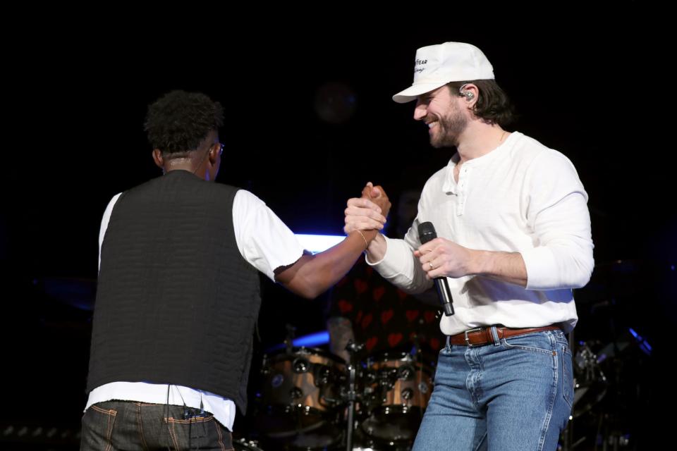 BRELAND and Sam Hunt perform onstage for "BRELAND & Friends" benefit for Oasis Center presented by Amazon Music at Ryman Auditorium on April 04, 2023 in Nashville, Tennessee.