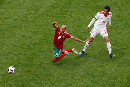 Soccer Football - World Cup - Group B - Morocco vs Iran - Saint Petersburg Stadium, Saint Petersburg, Russia - June 15, 2018 Morocco's Karim El Ahmadi in action with Iran's Vahid Amiri REUTERS/Lee Smith
