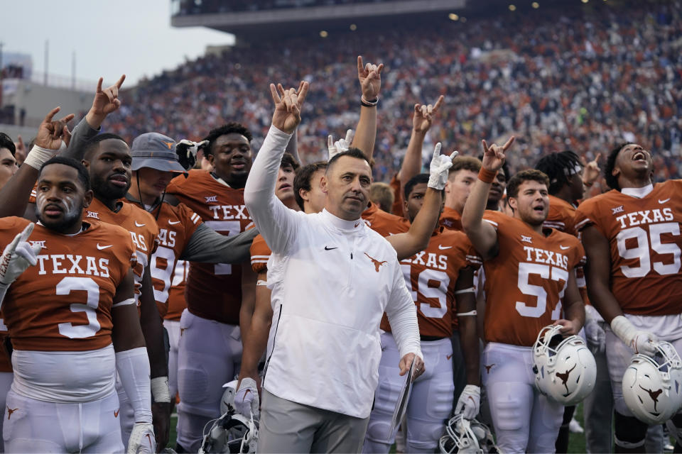 FILE - Texas head coach Steve Sarkisian, center, joins his team for the school song following their win over Baylor in an NCAA college football game in Austin, Texas, Friday, Nov. 25, 2022. Now with Texas set to join the Southeastern Conference, the Longhorn Network is set to quietly fold into the SEC network, shuttering a pioneering effort that briefly rocked not just the Big 12, but college football. (AP Photo/Eric Gay, File)
