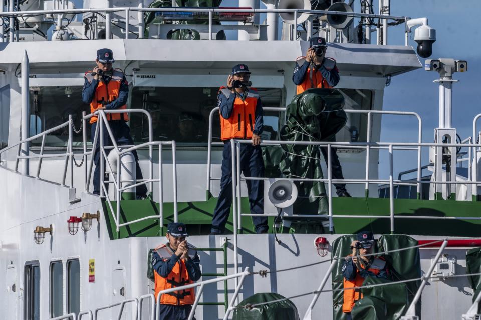 Chinese coast guards monitor Philippine Coast Guard vessels during the resupply mission to BRP Sierra Madre. (Photo: Lisa Marie David/Bloomberg)