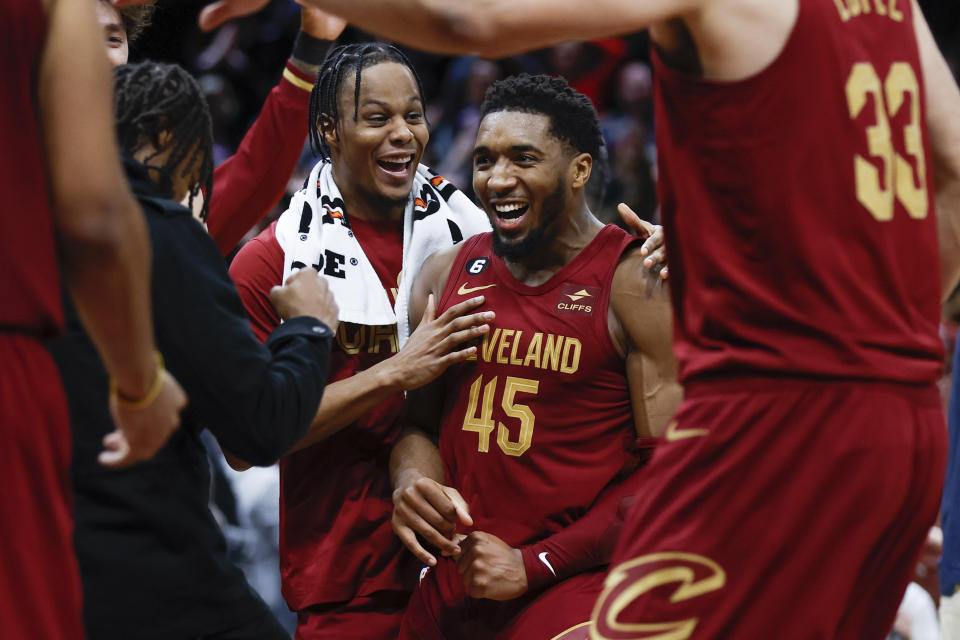 Cleveland Cavaliers guard Donovan Mitchell (45) celebrates with teammates after making a basket to tie an NBA basketball game during the second half against the Chicago Bulls, Monday, Jan. 2, 2023, in Cleveland. (AP Photo/Ron Schwane)