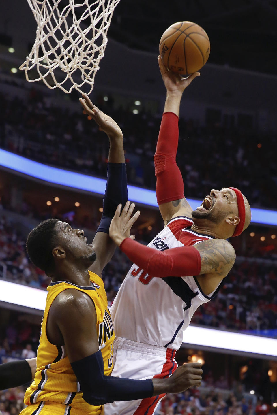 Washington Wizards forward Drew Gooden , right, shoots past Indiana Pacers center Roy Hibbert during the first half of Game 4 of an Eastern Conference semifinal NBA basketball playoff game in Washington, Sunday, May 11, 2014. (AP Photo/Alex Brandon)