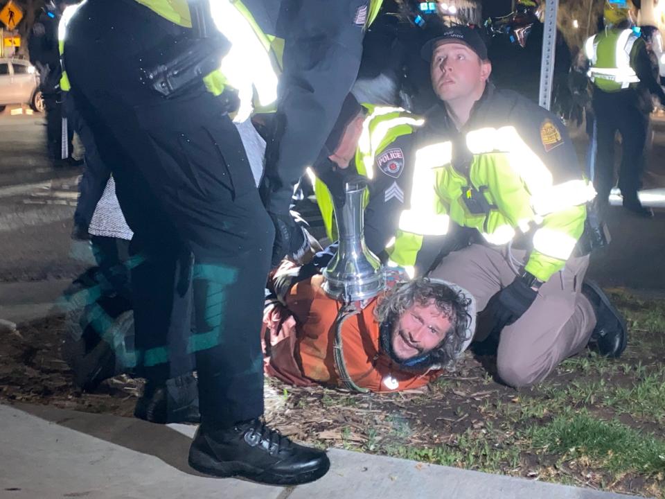 A man is arrested after being shot by a 40mm less lethal munition at the University of Utah on Monday, April 29, 2024.