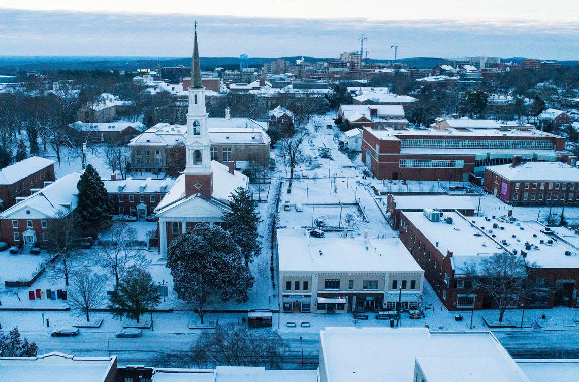 Snow is seen covering buildings and roads along Franklin Street and beyond in Chapel Hill, N.C. on Saturday morning, Jan. 22, 2022.