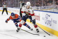 Florida Panthers' Matthew Tkachuk (19) is chased by Edmonton Oilers' Derek Ryan (10) during first-period NHL hockey game action in Edmonton, Alberta, Monday, Nov. 28, 2022. (Jason Franson/The Canadian Press via AP)