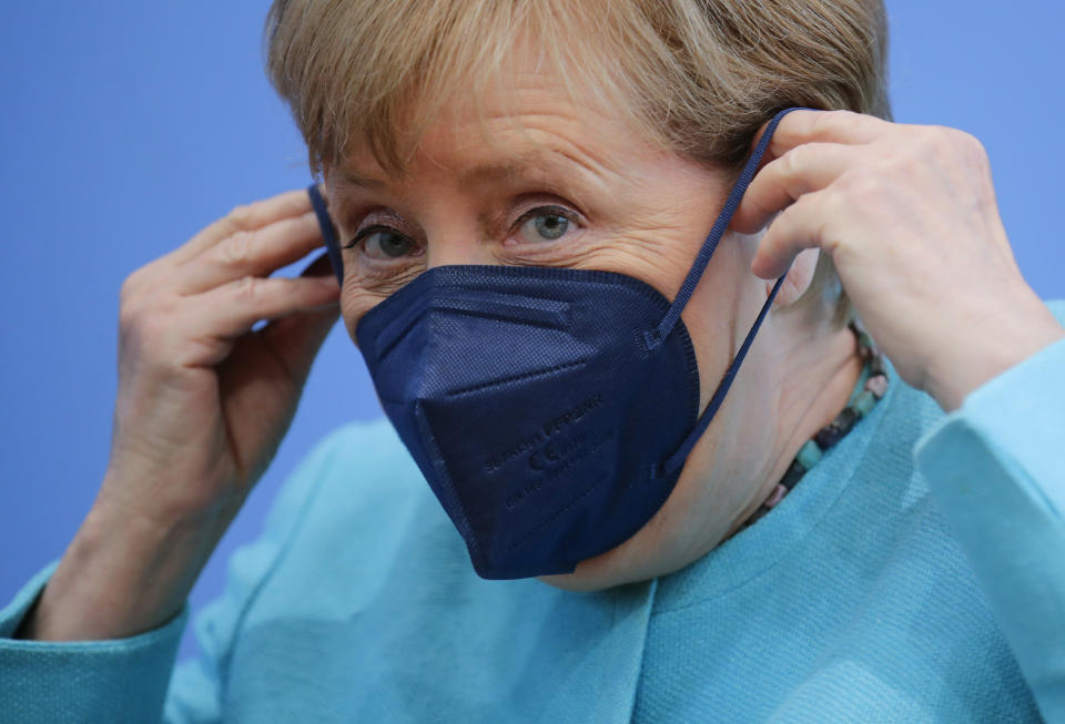 German Chancellor Angela Merkel puts on her face mask as she leaves, after her annual summer news conference in Berlin, Germany, Thursday, July 22, 2021. (Hannibal Hanschke/Pool Photo via AP)