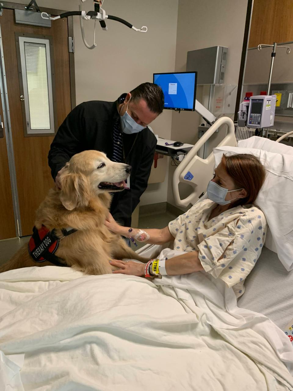 Therapy dog Yeti and his handler visit Victoria Threadgould at Dell Seton Medical Center the day after her kidney donation last week.