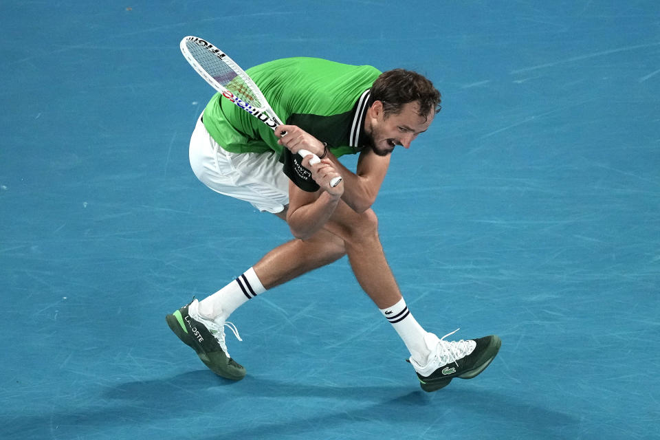 Daniil Medvedev of Russia hits a backhand to Jannik Sinner of Italy during the men's singles final at the Australian Open tennis championships at Melbourne Park, in Melbourne, Australia, Sunday, Jan. 28, 2024. (AP Photo/Louise Delmotte)