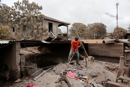 A man works in an affected area after the eruption of the Fuego volcano in San Miguel, Escuintla, Guatemala, June 8, 2018. REUTERS/Luis Echeverria