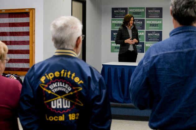 Whitmer looks on as Rep. Debbie Dingell (D-Mich.) speaks to attendees during a campaign event at the UAW Local 3000 offices on Oct. 26. (Photo: Brittany Greeson for HuffPost)