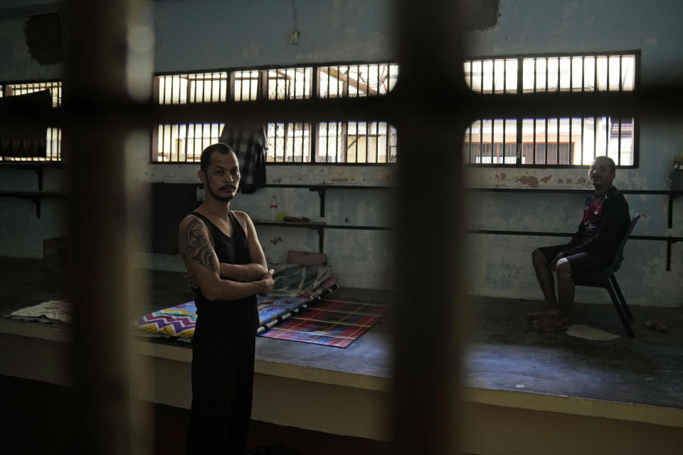 Two of four Myanmarese fishermen, stranded because they cannot afford to pay for their onward travel, rest inside their cell at Tanjungpinang Central Immigration Detention Center on Bintan Island, Indonesia, Wednesday, May 15, 2024. This three-story detention facility, with its barred windows and fading paint, is home to dozens of detainees facing uncertain futures, including whether they will ever return to their homelands, in conditions that closely resemble a prison. (AP Photo/Dita Alangkara)