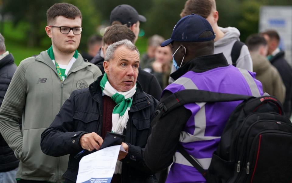 Football fans in Glasgow queuing up to show their vaccines passports at Tuesday's Europa League game - Andrew Milligan/PA Wire