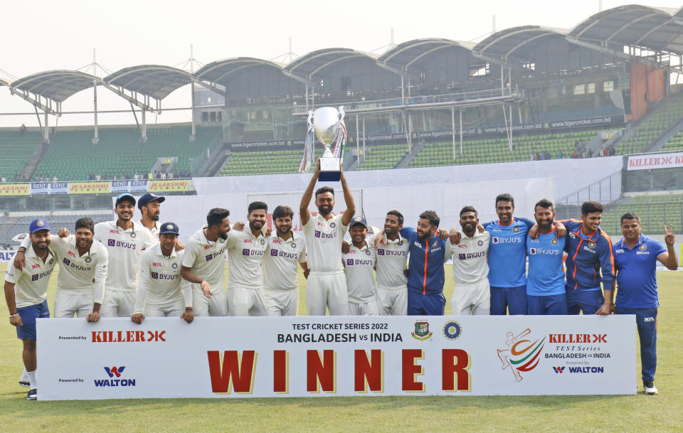 Indian team poses with the trophy after wining second cricket test match against Bangladesh in Dhaka, Bangladesh, Sunday, Dec. 25, 2022. (AP Photo/Surjeet Yadav)