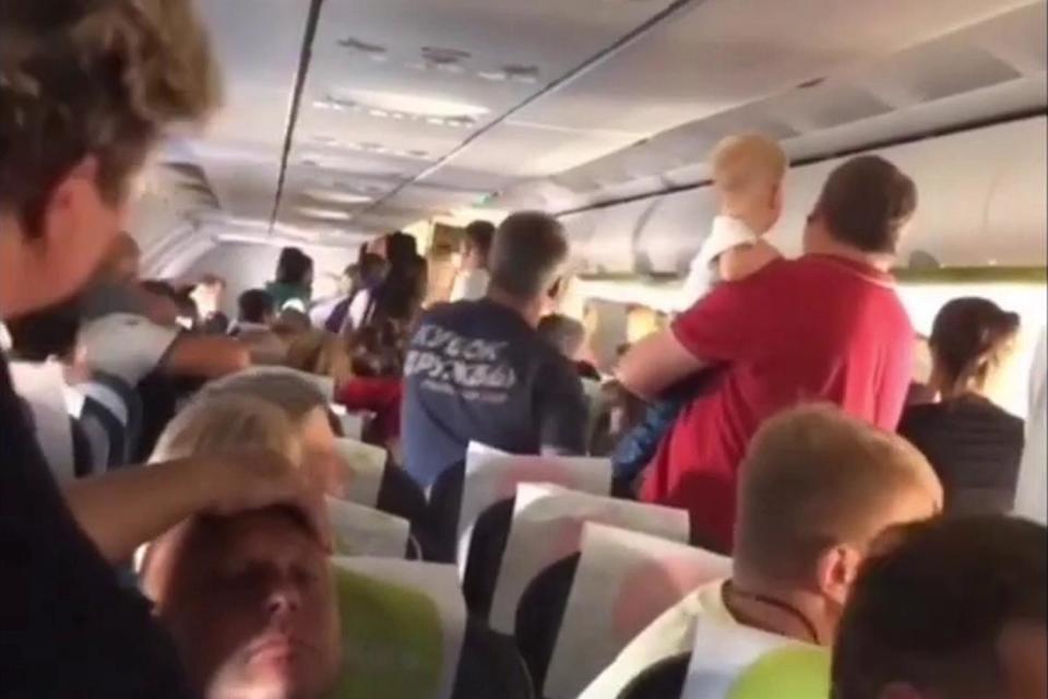 Passengers on the flight subdue and restrain the man