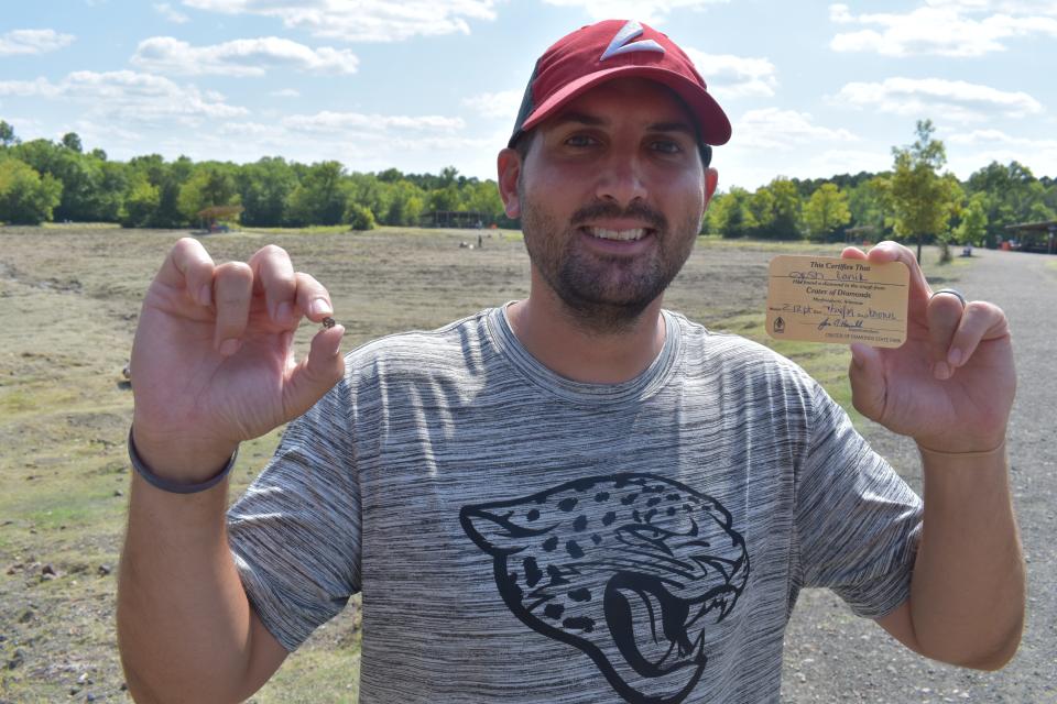 Josh Lanik with the 2.1 carat brown diamond he found at Crater of Diamonds State Park in Arkansas.