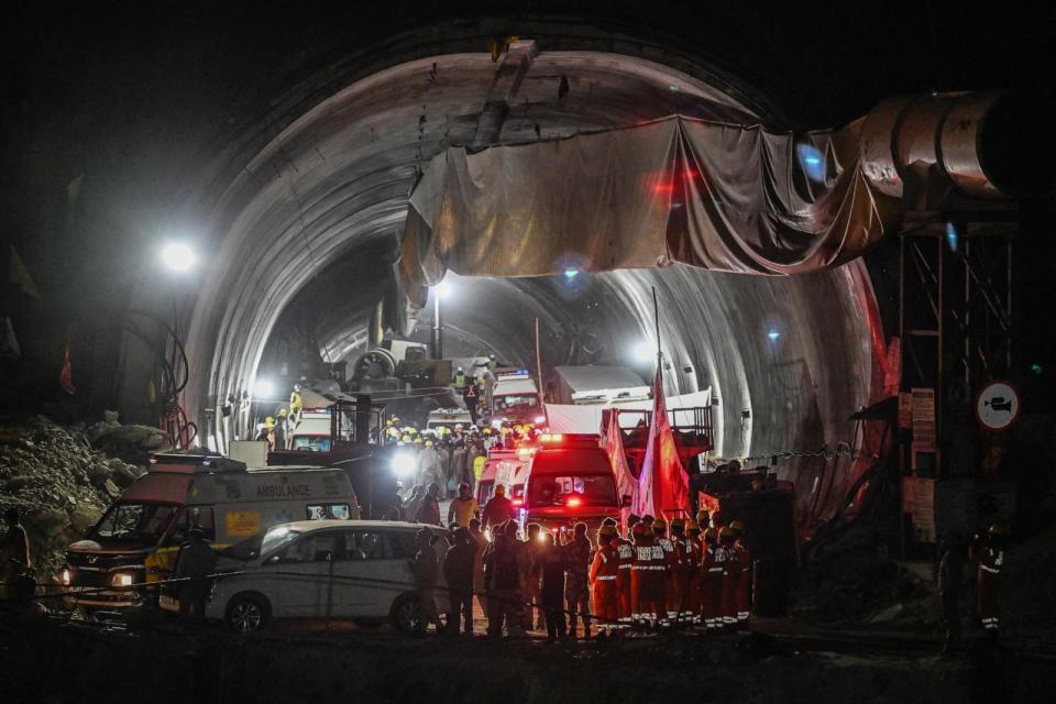 PHOTO: National Disaster Response Force personnel and rescue operatives gather at the entrance of the Silkyara during a rescue operation for trapped workers after a section of the tunnel collapsed, in the Uttarkashi district of India on Nov. 28, 2023. (Sajjad Hussain/AFP via Getty Images)