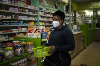 Sister Sylvia Simpwalo pays for HIV medication for her patients in downtown Johannesburg, South Africa, Thursday, July 30, 2020. Across Africa and around the world, the COVID-19 pandemic has disrupted the supply of antiretroviral drugs to many of the more than 24 million people who take them, endangering their lives. An estimated 7.7 million people in South Africa are HIV positive, the largest number in the world, and 62% of them take the antiretroviral drugs that suppress the virus and prevent transmission. (AP Photo/Bram Janssen)