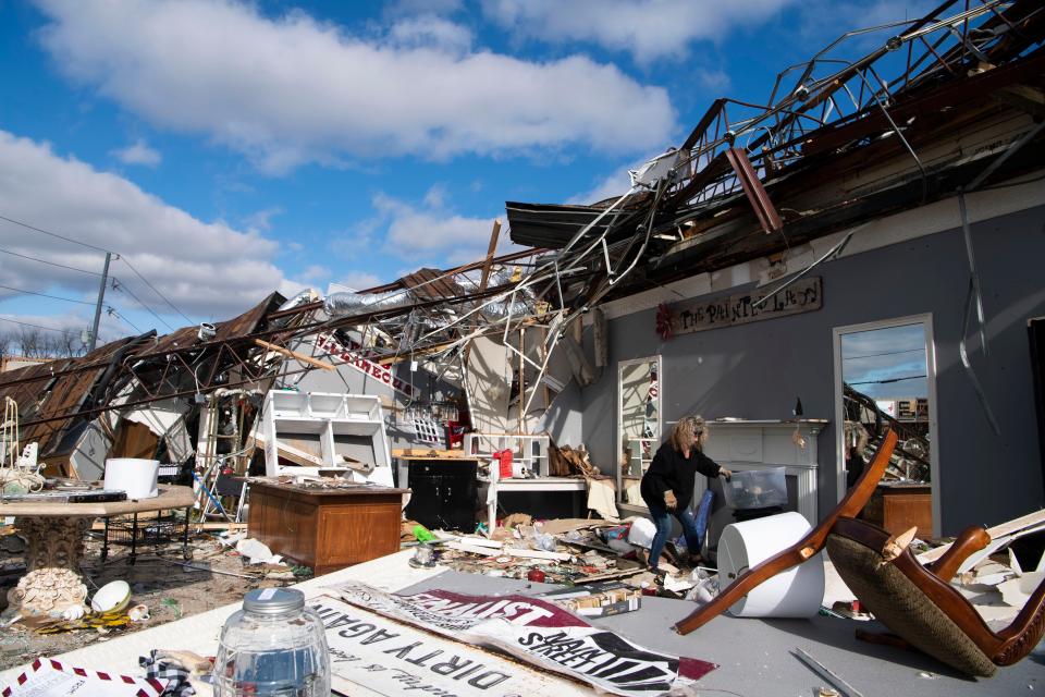 Kathy Moss, owner of the The Painted Lady miscellaneous store on Main Street moves furniture around, seeing what she can salvage from her store in Hendersonville, Tenn., Sunday, Dec. 10, 2023.