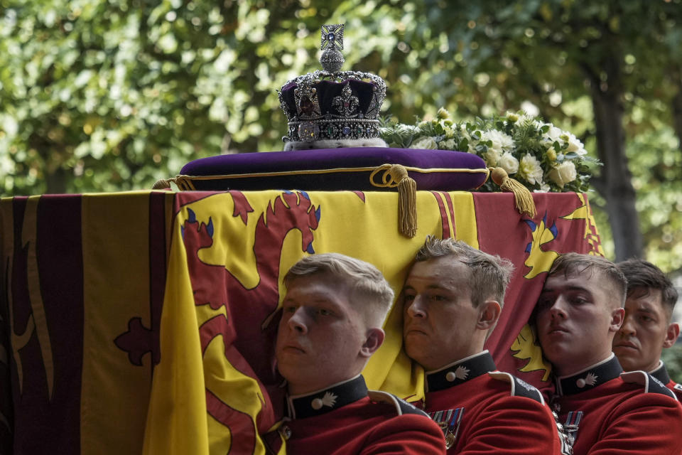 Pallbearers from The Queen's Company, 1st Battalion Grenadier Guards carry the coffin of Queen Elizabeth II into Westminster Hall at the Palace of Westminster in London on September 14, 2022, to Lie in State following a procession from Buckingham Palace. - Queen Elizabeth II will lie in state in Westminster Hall inside the Palace of Westminster, from Wednesday until a few hours before her funeral on Monday, with huge queues expected to file past her coffin to pay their respects. (Photo by Emilio Morenatti / POOL / AFP) (Photo by EMILIO MORENATTI/POOL/AFP via Getty Images)