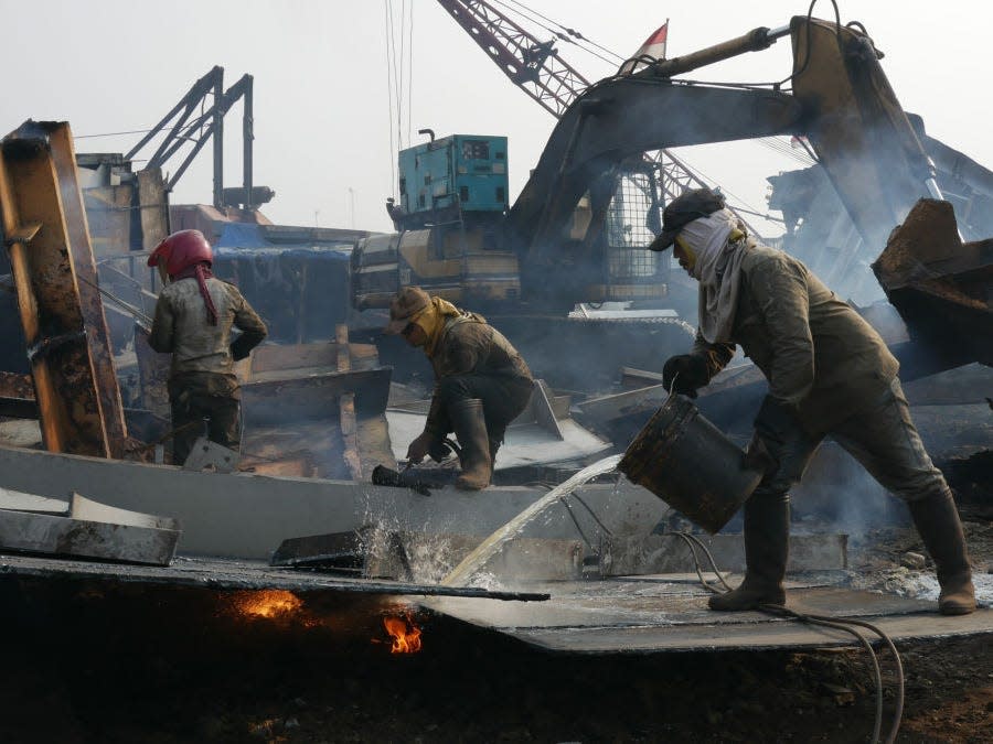 Workers demolish old ships at a shipbreaking yards Kalibaru in Jakarta, Indonesia on September 27, 2018.