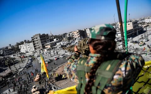 A female sniper of the Syrian Democratic Forces - Credit: AFP