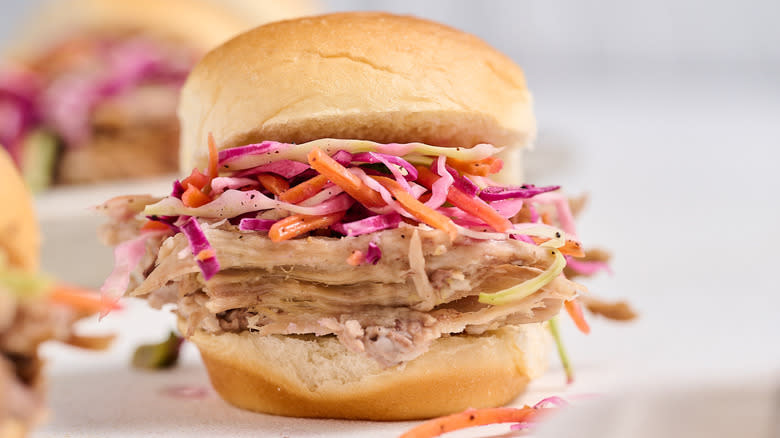 pulled pork sandwich with coleslaw on table