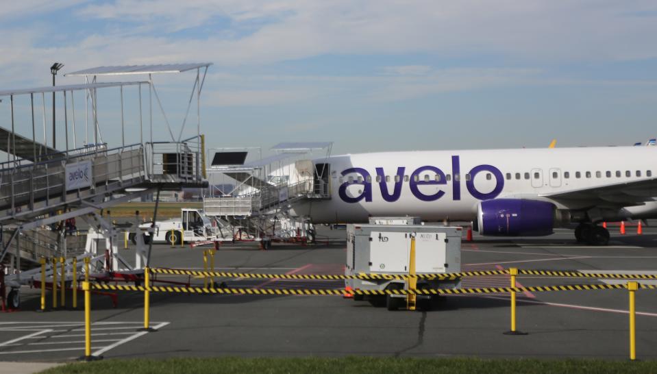 An Avelo Airlines plane sits at the Wilmington Airport waiting for passengers to board.