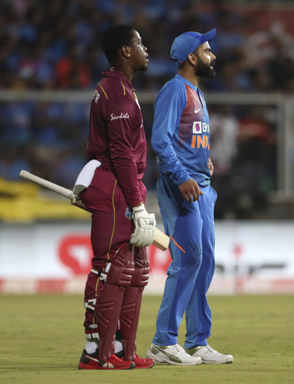 India's captain Virat Kohli, right, and West Indies' Shimron Hetmyer watch the replay of Hetmyer's dismissal as they await umpire's decision during the second Twenty20 international cricket match between India and West Indies in Thiruvanathapuram, India, Sunday, Dec. 8, 2019. (AP Photo/Aijaz Rahi)