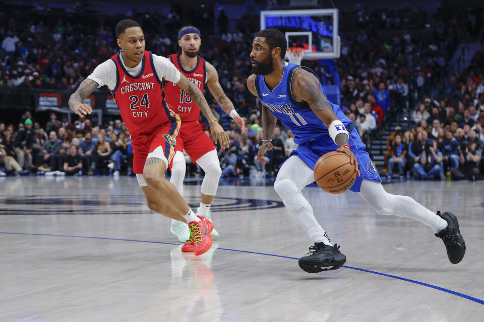 Dallas Mavericks guard Kyrie Irving (11) drives against New Orleans Pelicans guard Jordan Hawkins (24) during the second half of an NBA basketball game Saturday, Jan. 13, 2024, in Dallas. (AP Photo/Brandon Wade)