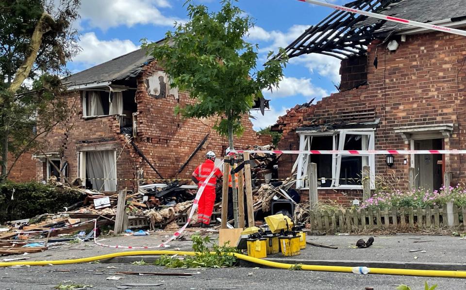 Emergency services at the scene in Dulwich Road, Kingstanding, in Birmingham, where a woman has been found dead after a house was destroyed in a gas explosion - Richard Vernalls/PA Wire