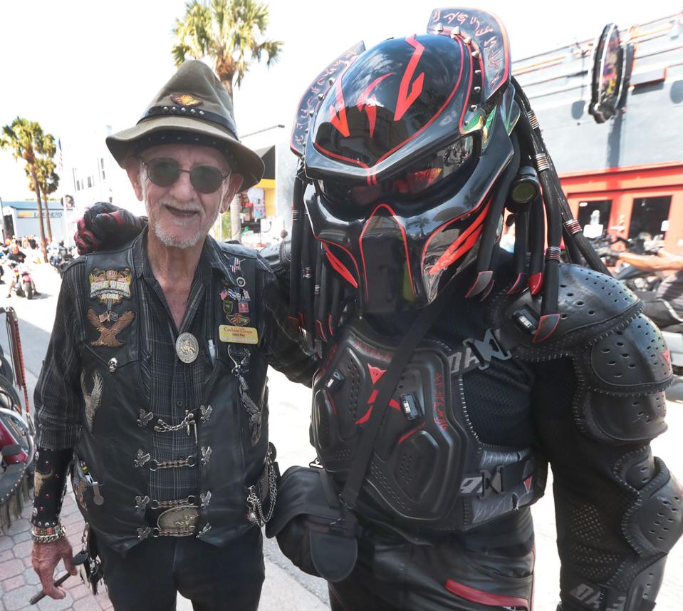Old biker meets alien biker on Main Street as Bike Week rolls toward its closing weekend in Daytona Beach. Although Main Street merchants report booming business, area hoteliers had a harder time filling rooms, possibly due to rainy weather forecasts.