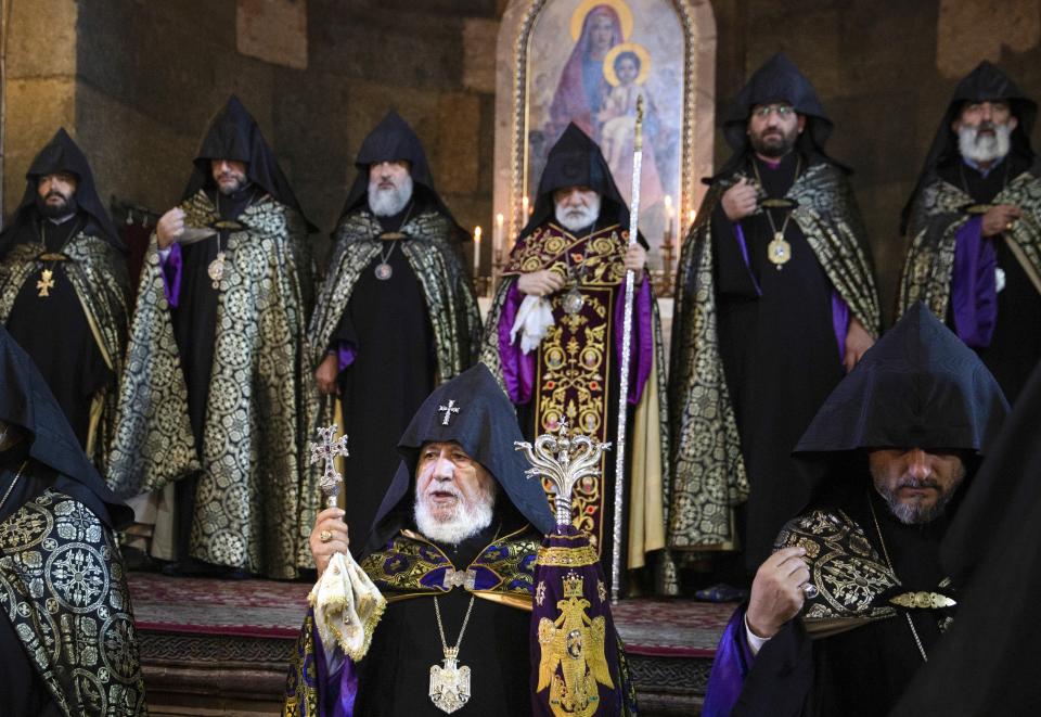 Armenian Apostolic Church leader Catholicos Garegin II, center, attends a religion service of remembrance of those killed in a war over the Nagorno-Karabakh region, at the Armenian Apostolic Cathedral in Etchmiadzin, the seat of the Oriental Orthodox church outside Yerevan, Armenia, Monday, Sept. 27, 2021. Azerbaijan and Armenia are marking the first anniversary of the start of their six-week war in which more than 6,600 people died and that ended with Azerbaijan regaining control of large swaths of territory. In Yerevan, the Armenian capital, thousands of people went to the Yerablur military cemetery to pay respects to soldiers buried there. (Grigor Yepremyan/PAN Photo via AP)