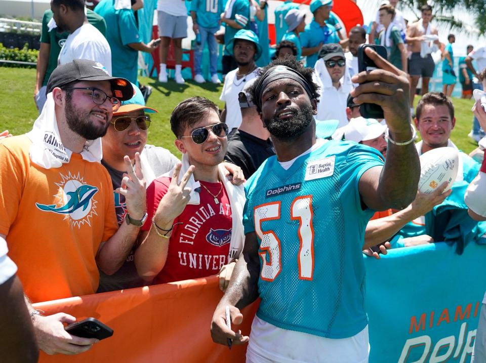 Miami Dolphins linebacker David Long (51) poses for a selfie with fans at training camp at Baptist Health Training Complex, Sunday, July 30, 2023 in Miami Gardens.