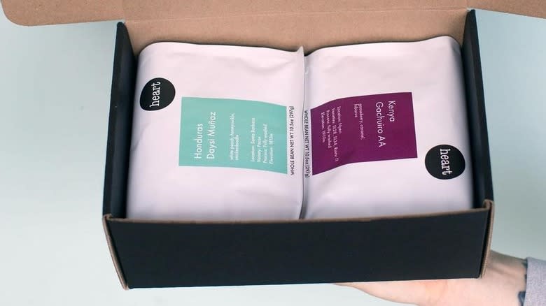 hand holding box of coffee bags