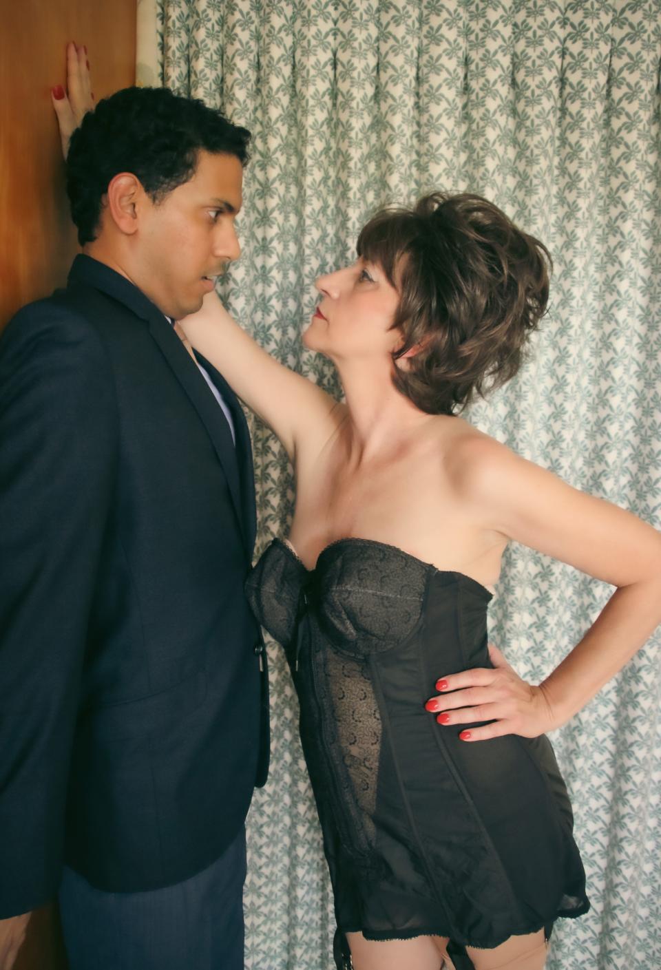 Anuj Naidu, left, as Benjamin Braddock and Eve Caballero as Mrs. Robinson in “The Graduate” presented by The Players Centre and Two Chairs Theatre Company.