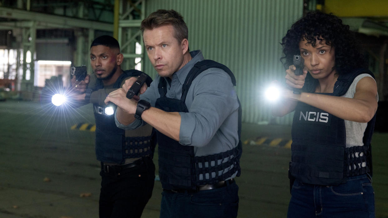  Olivia Swann, Todd Lasance and Sean Sagar with guns drawn in NCIS: Sydney. 