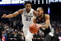 Providence guard Jared Bynum (4) drives for the basket past Xavier's Jerome Hunter (21) during the first half of an NCAA college basketball game, Wednesday, Jan. 26, 2022, in Cincinnati. (AP Photo/Jeff Dean)