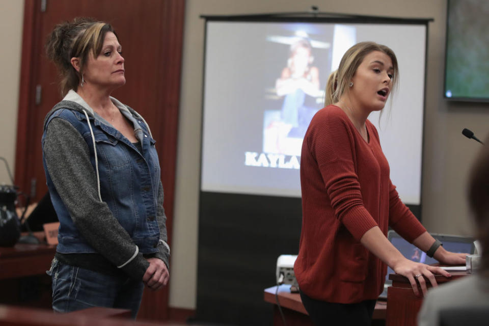 With her mother by her side, Kayla Spicher, right, delivers a victim impact statement at the sentencing hearing for Larry Nassar, who has been accused of molesting more than 100 girls while he was a physician for USA Gymnastics and Michigan State University. (Photo: Scott Olson/Getty Images)